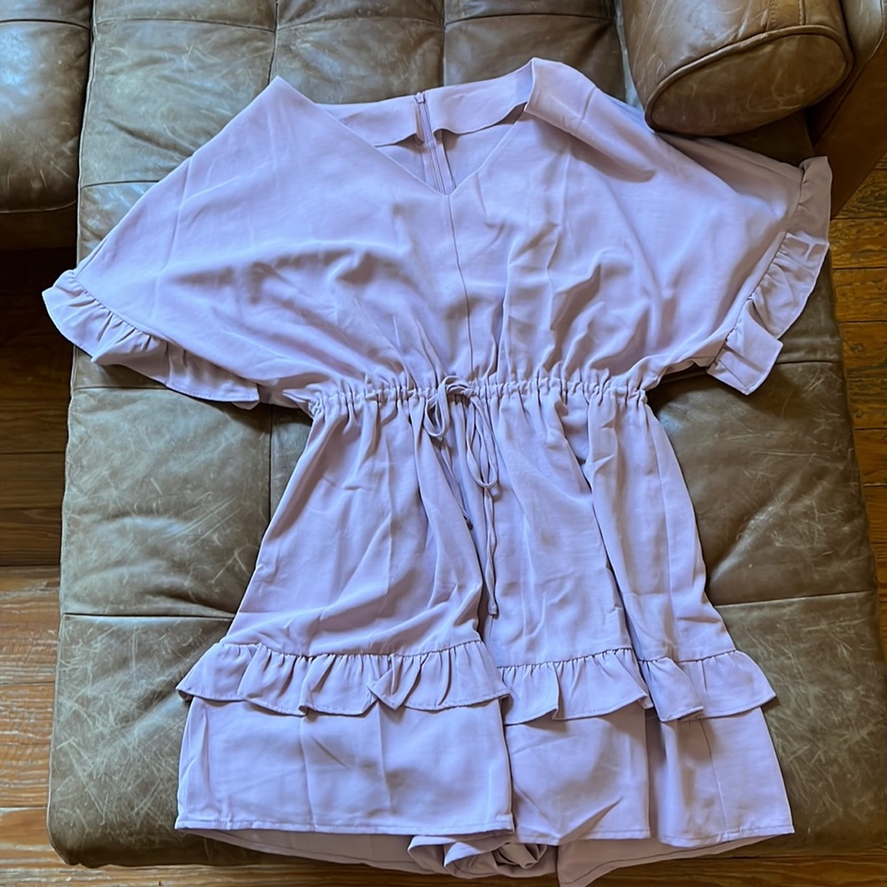 Pink romper is its cinched waste
